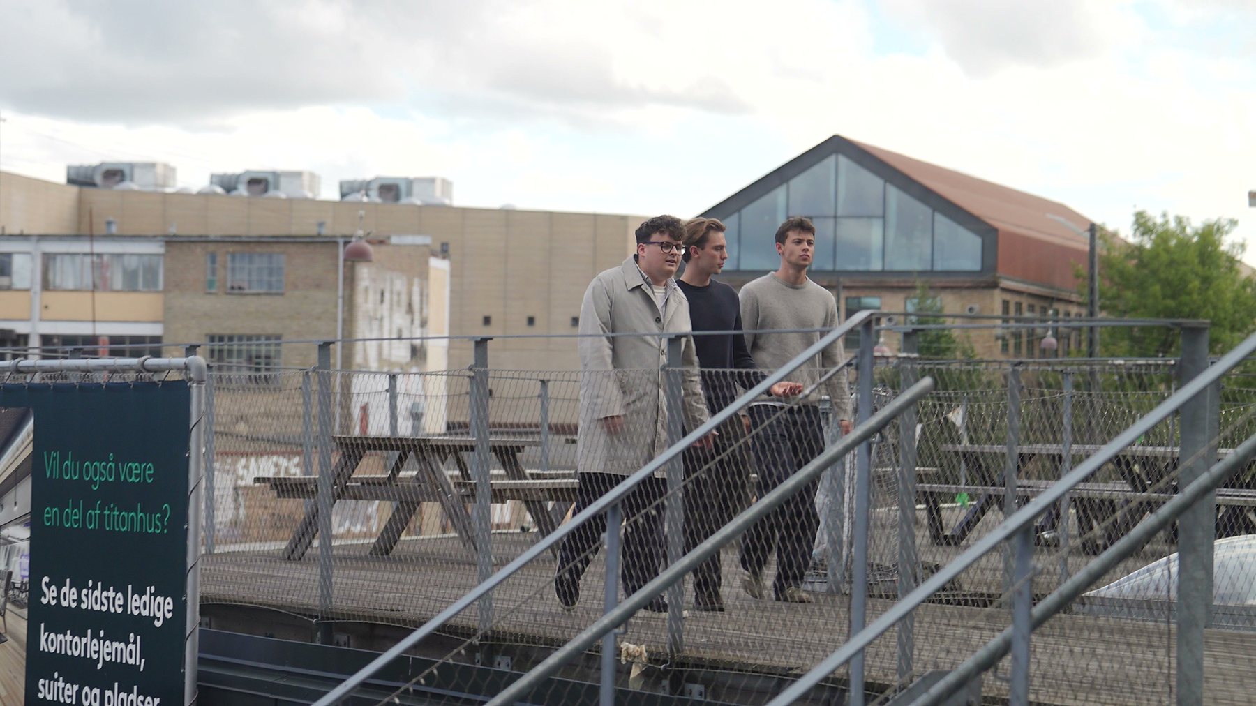 Three colleagues crossing the terrace outside the office