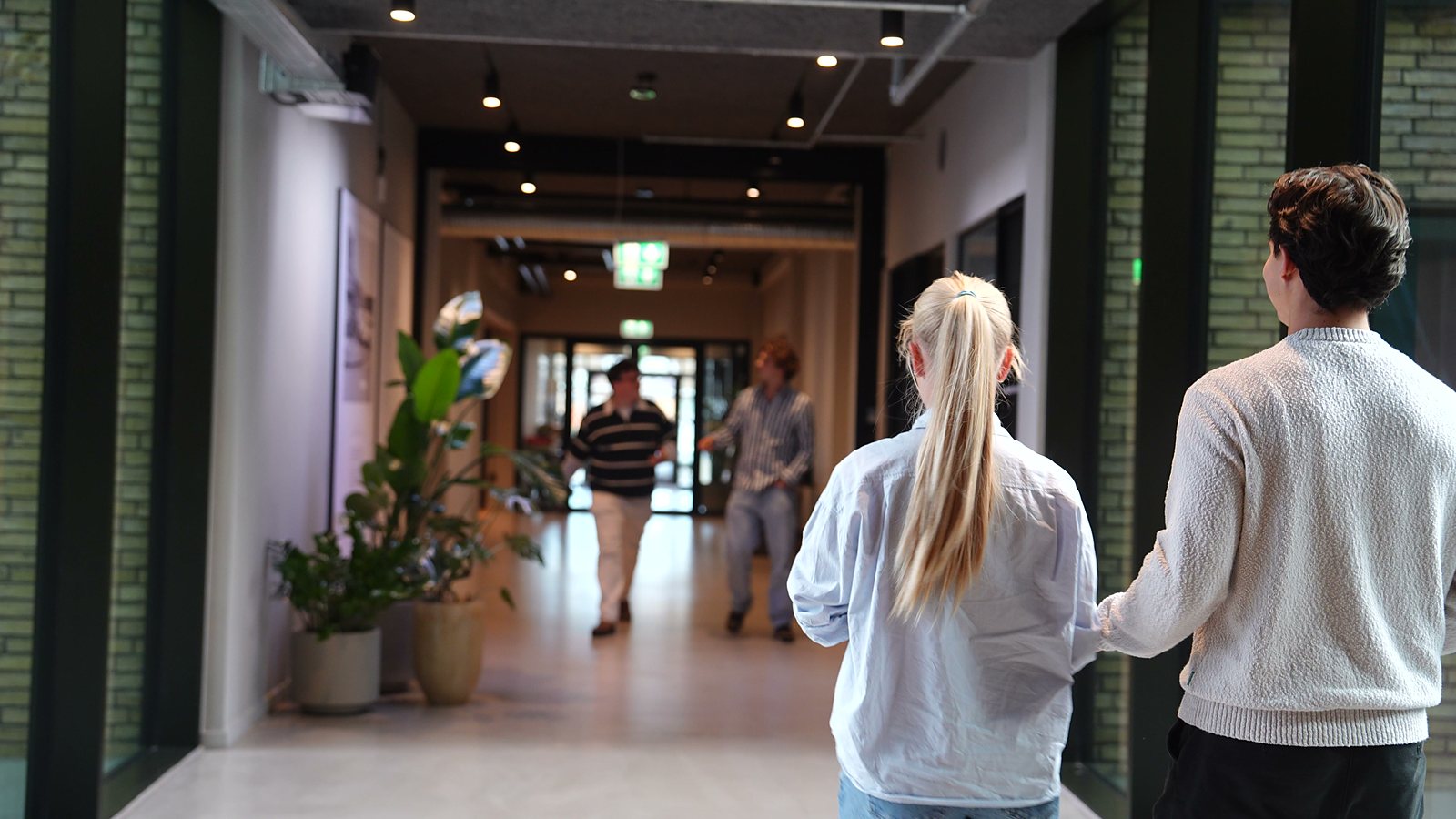 Two colleagues walking down the corridor together
