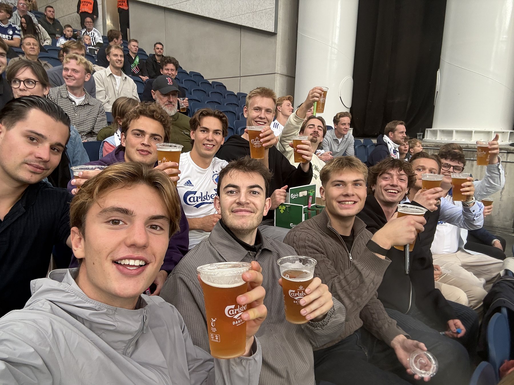 The team in the stands at Parken, beers in hand